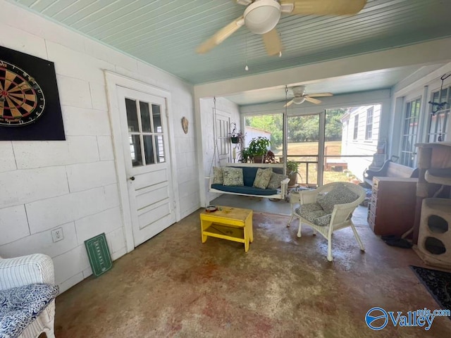 sunroom / solarium featuring ceiling fan