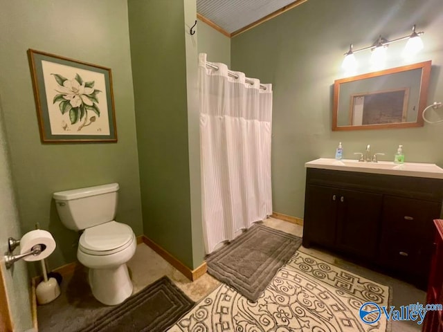 bathroom featuring vanity, toilet, ornamental molding, and walk in shower