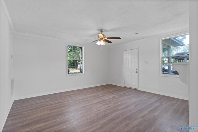 unfurnished living room featuring ornamental molding, dark hardwood / wood-style flooring, ceiling fan, and a textured ceiling