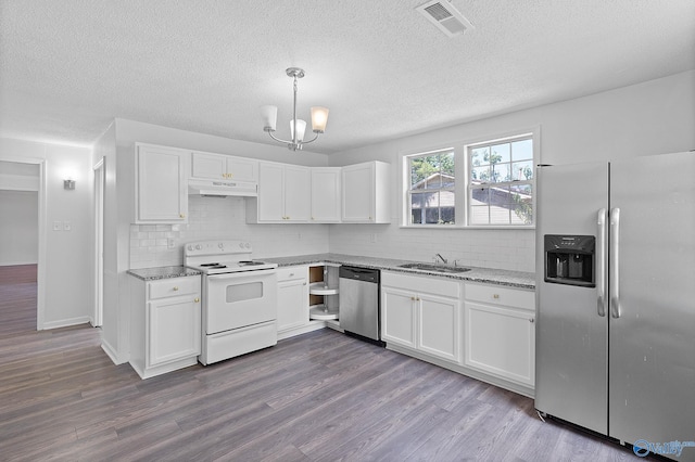 kitchen featuring stainless steel appliances, hardwood / wood-style floors, and white cabinets