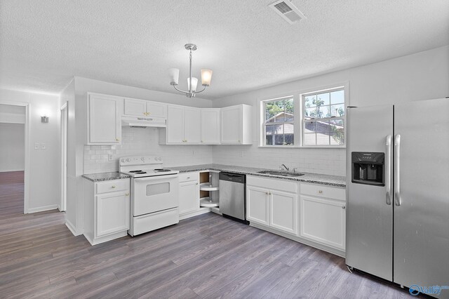 kitchen featuring white cabinets, appliances with stainless steel finishes, plenty of natural light, and light hardwood / wood-style floors