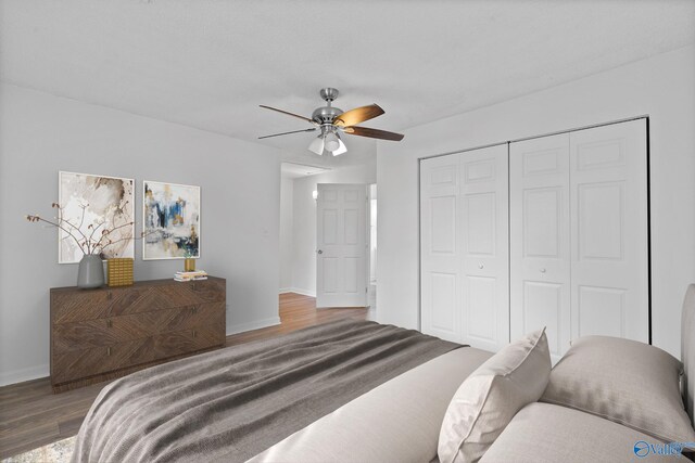 unfurnished bedroom with ceiling fan, a closet, and light hardwood / wood-style floors