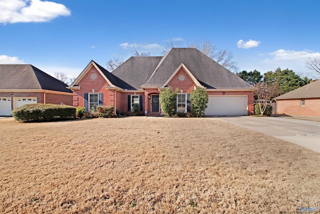 view of front facade featuring driveway, an attached garage, and brick siding