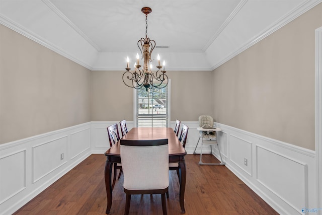 dining area with dark wood finished floors, a notable chandelier, and a decorative wall