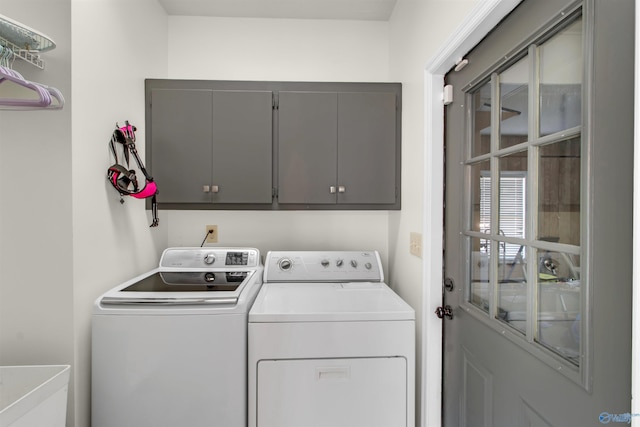 clothes washing area with cabinet space and washer and dryer