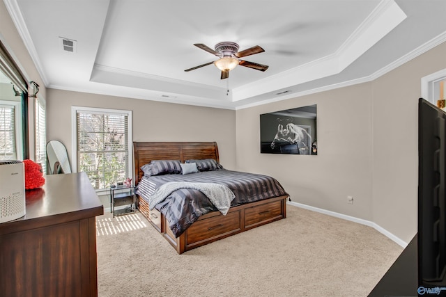 bedroom with a raised ceiling, visible vents, crown molding, and carpet flooring