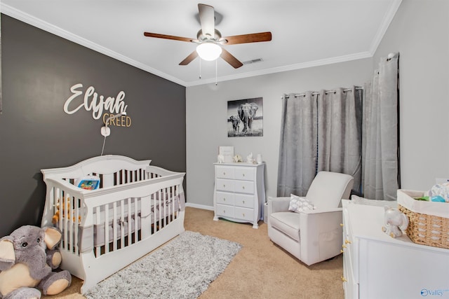 carpeted bedroom with ornamental molding, a nursery area, visible vents, and a ceiling fan