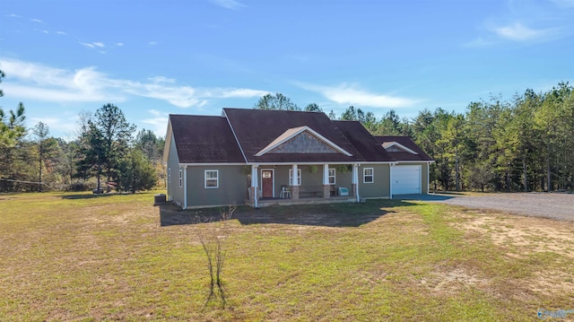 view of front of home with a porch, a garage, and a front lawn