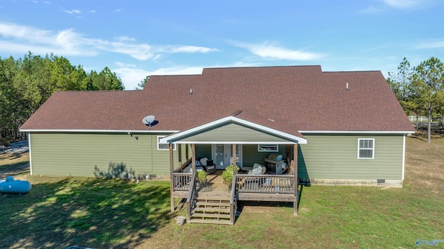 rear view of house with a deck and a yard