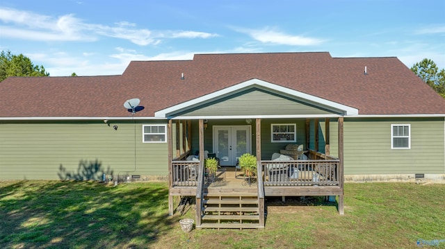 back of house featuring a lawn and a wooden deck