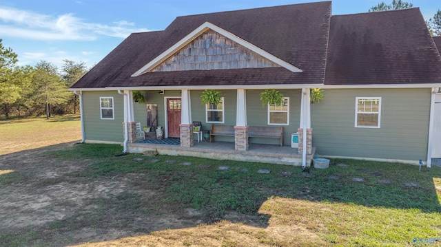 craftsman inspired home with a porch and a front yard