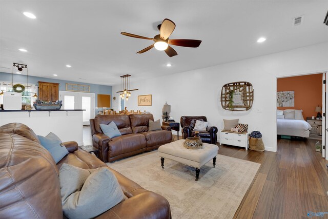 living room with ceiling fan and wood-type flooring