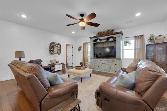 living room with ceiling fan and light hardwood / wood-style flooring