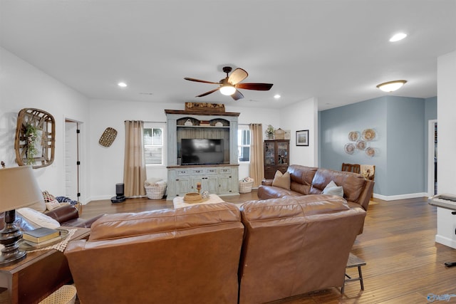 living room featuring hardwood / wood-style flooring and ceiling fan