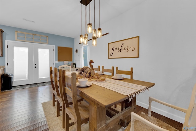 dining space featuring french doors and dark hardwood / wood-style flooring