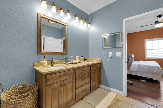 bathroom with hardwood / wood-style flooring, ceiling fan, and vanity