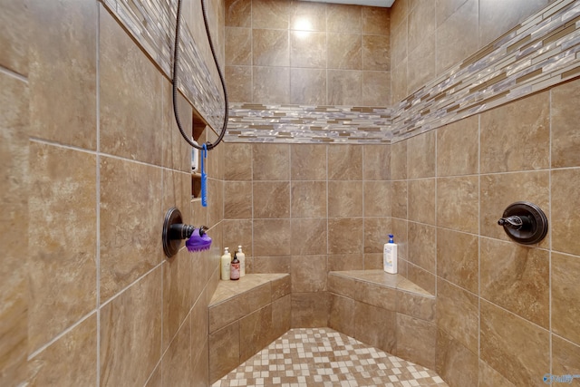 bathroom with a tile shower