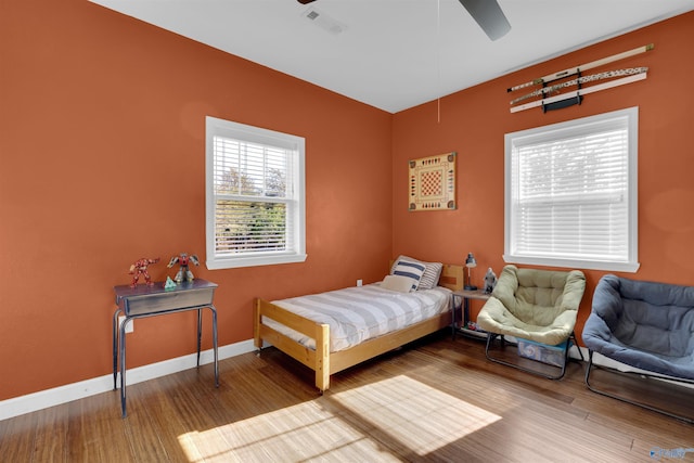 bedroom with ceiling fan and wood-type flooring