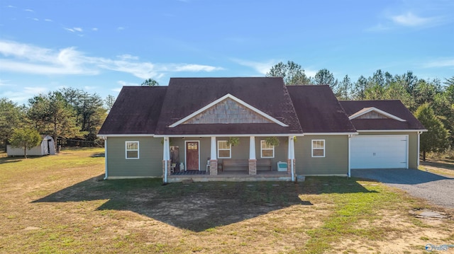 craftsman-style home with a porch, a storage unit, a garage, and a front lawn