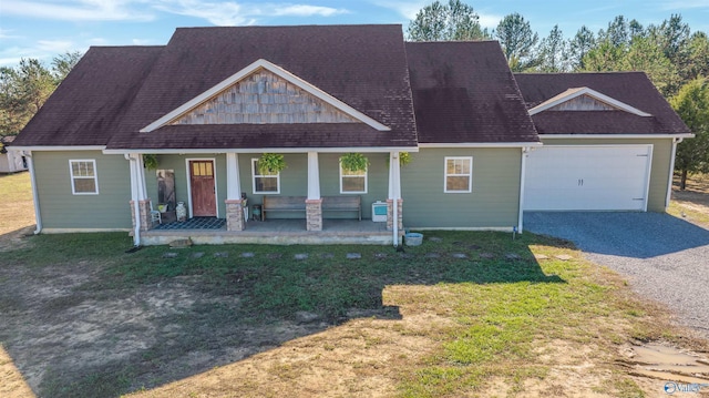 view of front of house featuring a front lawn, a porch, and a garage