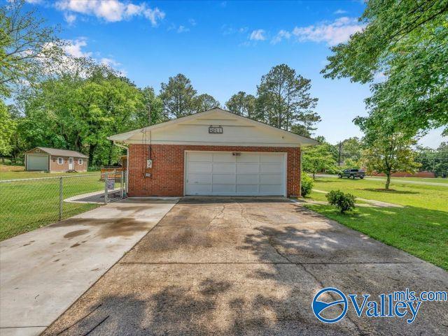 detached garage featuring fence