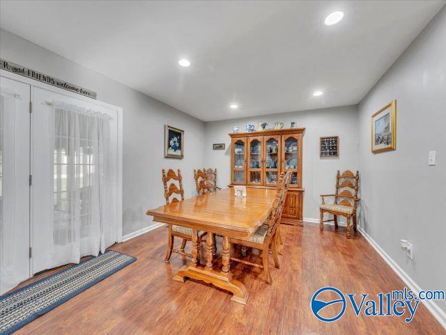 dining room with recessed lighting, baseboards, and wood finished floors