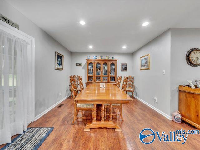 dining area with recessed lighting, baseboards, and wood finished floors