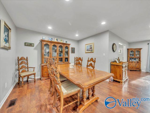 dining room featuring baseboards, recessed lighting, light wood-style flooring, and visible vents