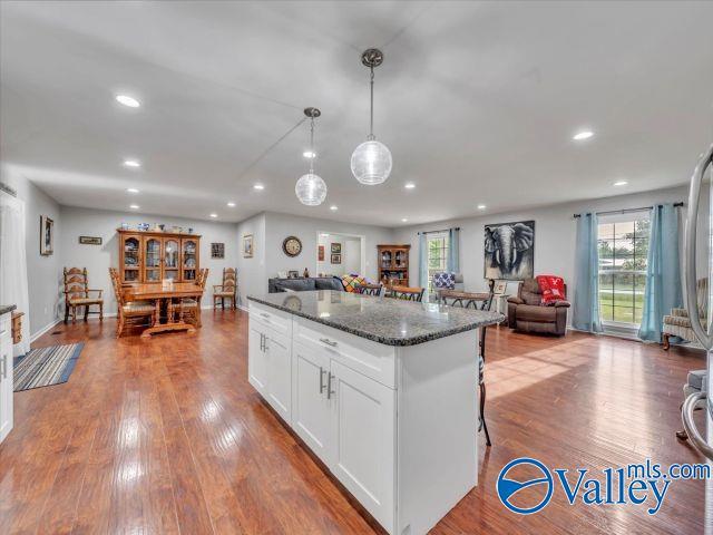 kitchen featuring recessed lighting, white cabinetry, dark stone countertops, and a healthy amount of sunlight
