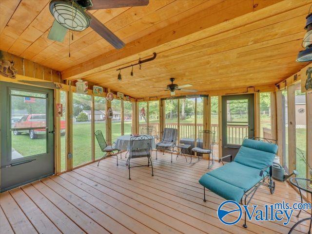 sunroom / solarium featuring a ceiling fan and rail lighting
