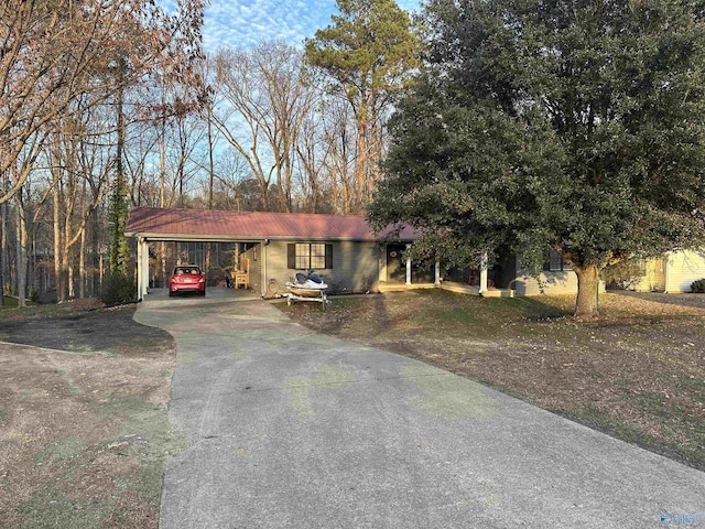 view of front of home with a carport and a front yard