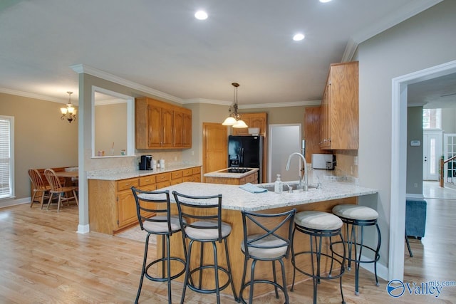 14850 Creek Ln, Athens, AL 35613 - kitchen with black fridge with ice dispenser, a sink, backsplash, light wood-type flooring, and baseboards