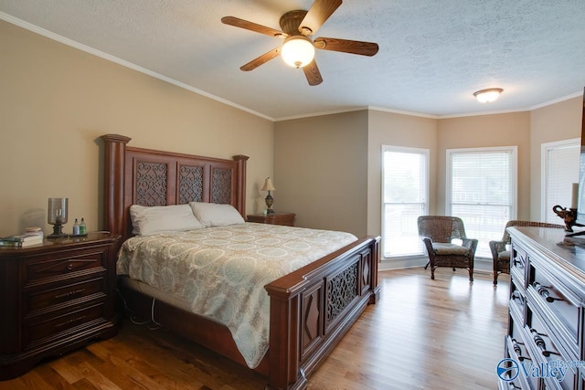 14850 Creek Ln, Athens, AL 35613 - bedroom with wood finished floors, a textured ceiling, crown molding, and ceiling fan