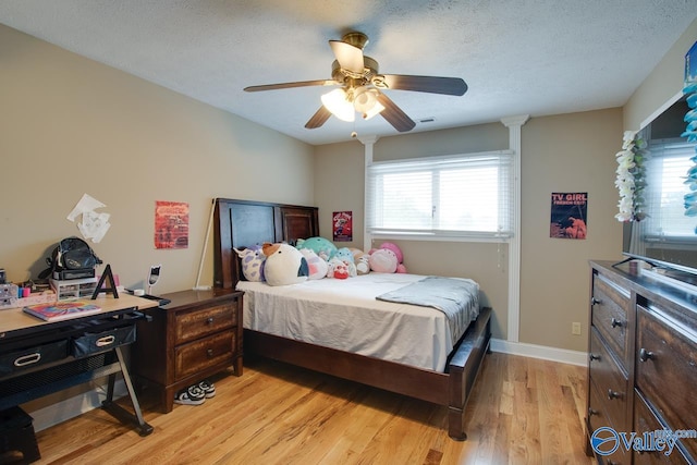 14850 Creek Ln, Athens, AL 35613 - bedroom featuring light wood-style flooring, a ceiling fan, baseboards, and a textured ceiling