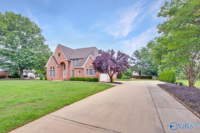 14850 Creek Ln, Athens, AL 35613 - view of front facade featuring driveway, a front lawn, brick siding, and a garage