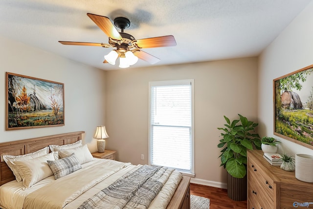 bedroom with ceiling fan and wood-type flooring