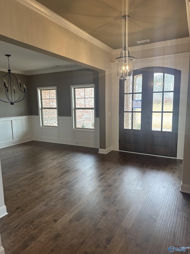foyer entrance featuring visible vents, a notable chandelier, dark wood finished floors, and french doors