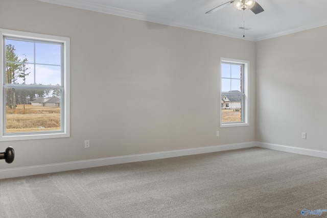 empty room featuring carpet floors, ceiling fan, baseboards, and ornamental molding