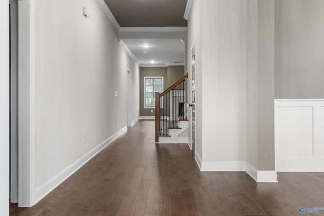 hall featuring ornamental molding, stairs, baseboards, and dark wood-style flooring