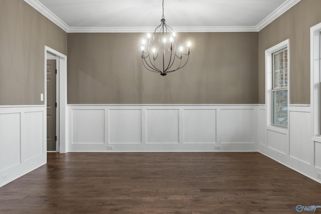 unfurnished dining area with crown molding, a decorative wall, a notable chandelier, and dark wood-style flooring