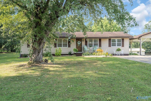 single story home with concrete driveway and a front yard