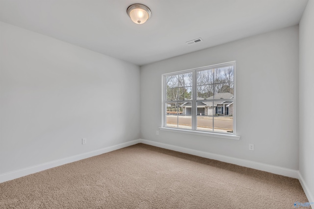 unfurnished room featuring visible vents, baseboards, and carpet floors