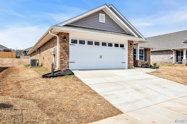 view of front of property with a garage and central air condition unit