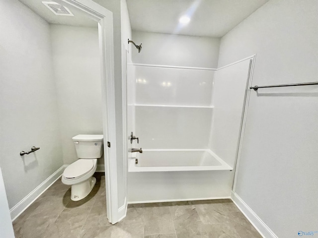 bathroom featuring visible vents, baseboards, toilet, and bathtub / shower combination