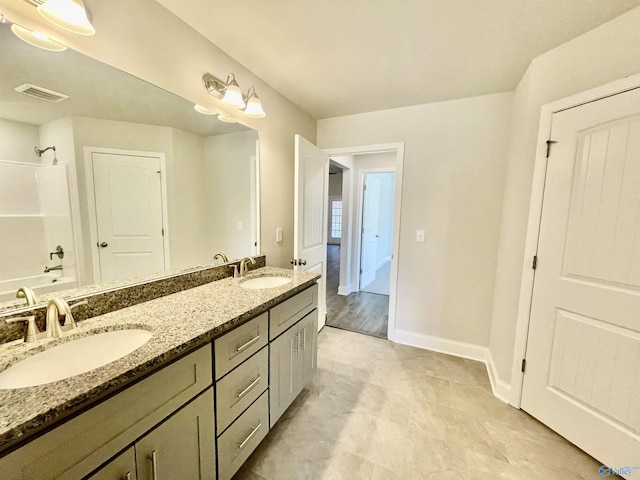 bathroom with double vanity, visible vents, shower / bath combination, and a sink