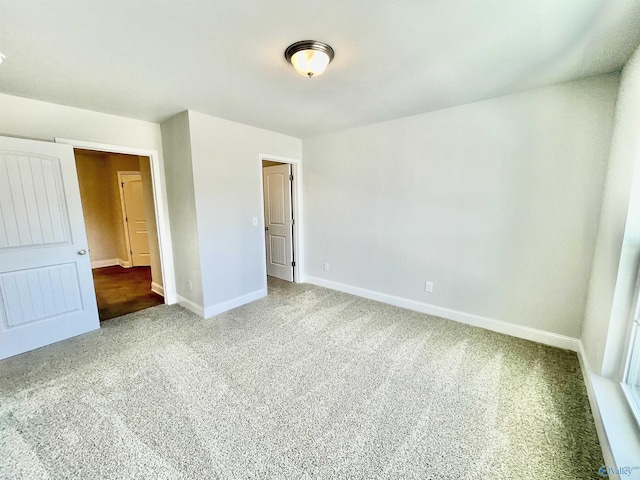 unfurnished bedroom featuring baseboards and carpet