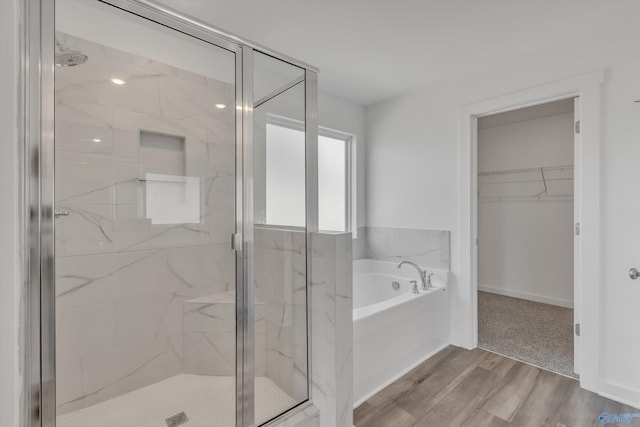 bathroom featuring hardwood / wood-style flooring and separate shower and tub