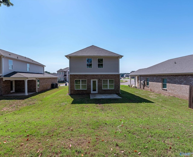 rear view of house featuring a yard and a patio area