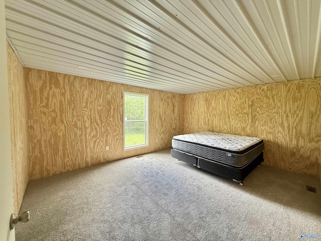 bedroom featuring carpet and wood walls