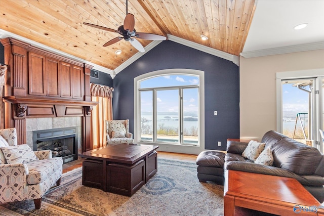 living room with wood ceiling, lofted ceiling, ornamental molding, wood finished floors, and a ceiling fan